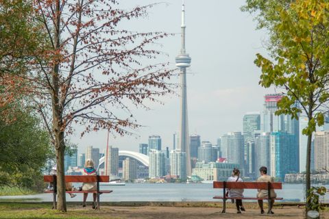 Two Blueseven cleaners cleaning a window, representative of condo and house cleaning across Toronto